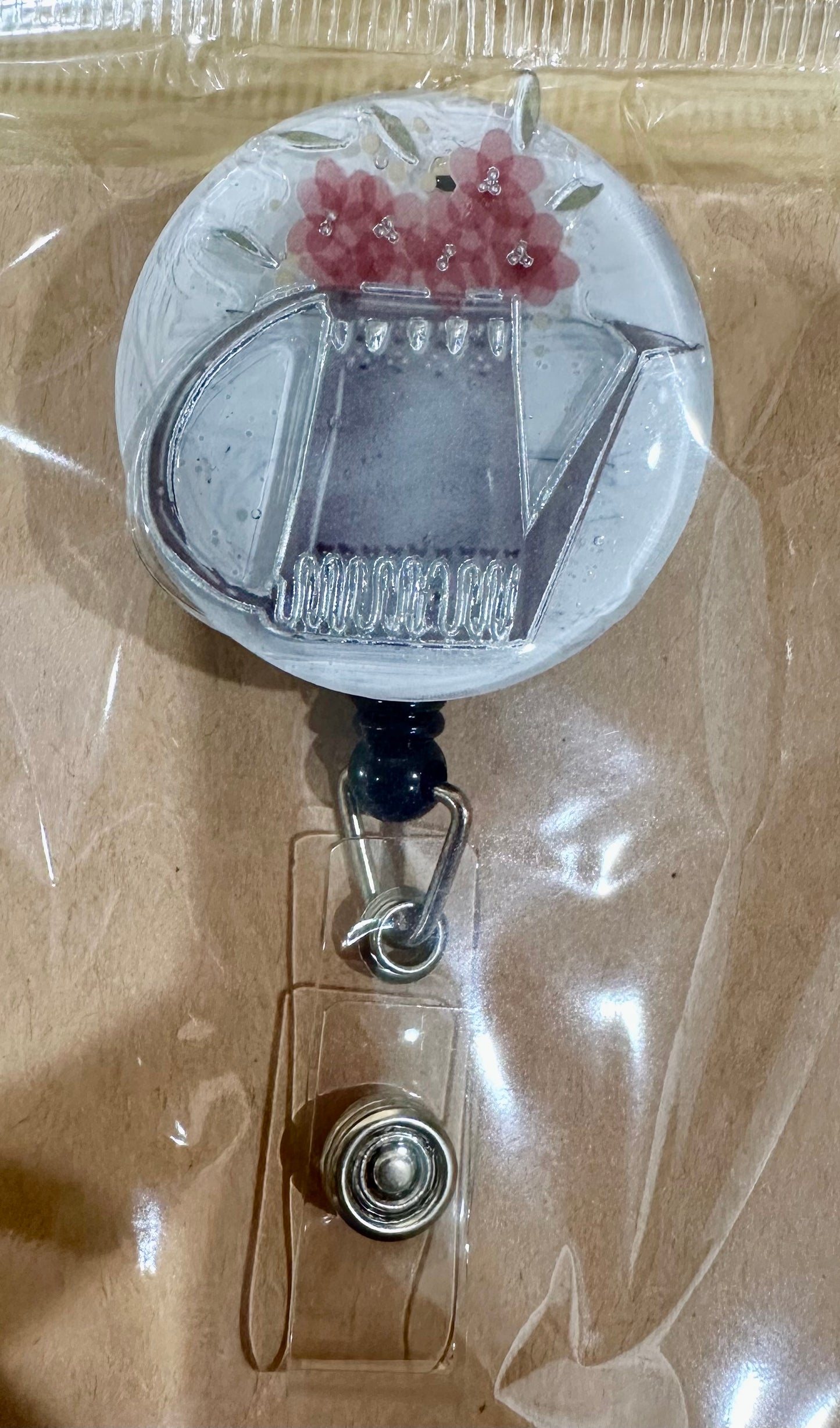 Floral wateting can badge reel with belt clip