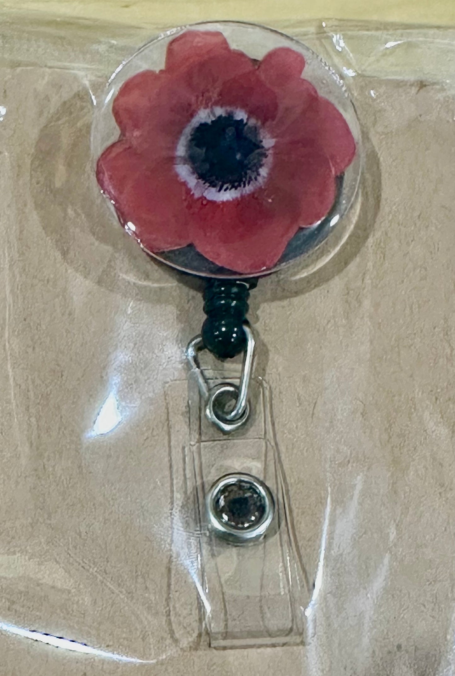 Red flower badge reel with belt clip