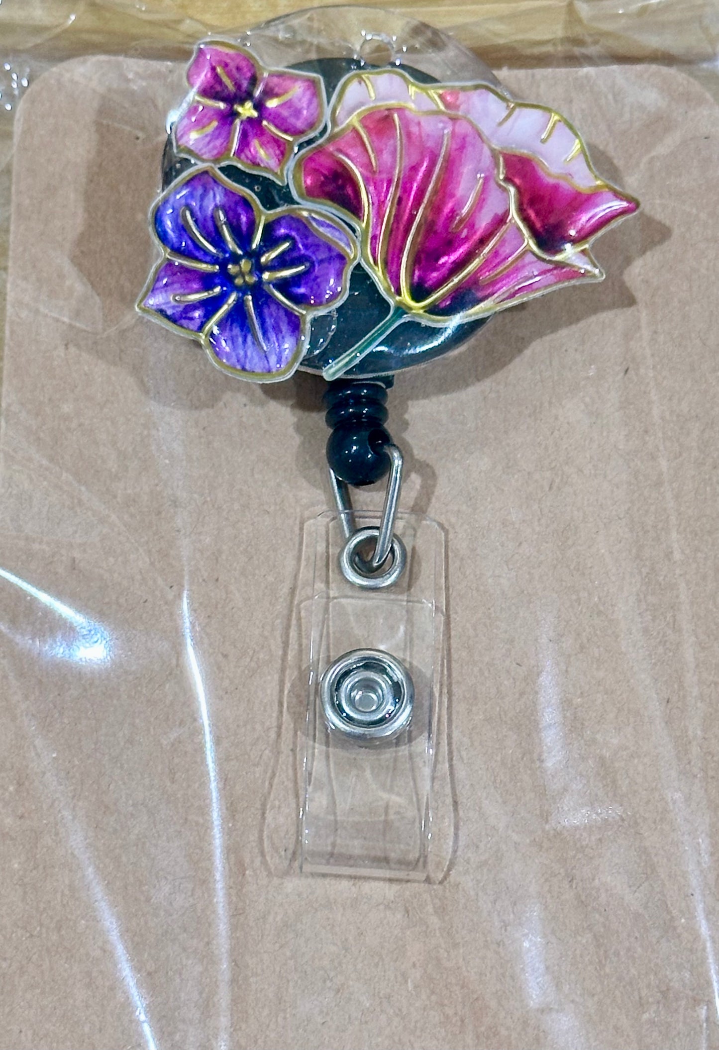 Floral badge reel with belt clip