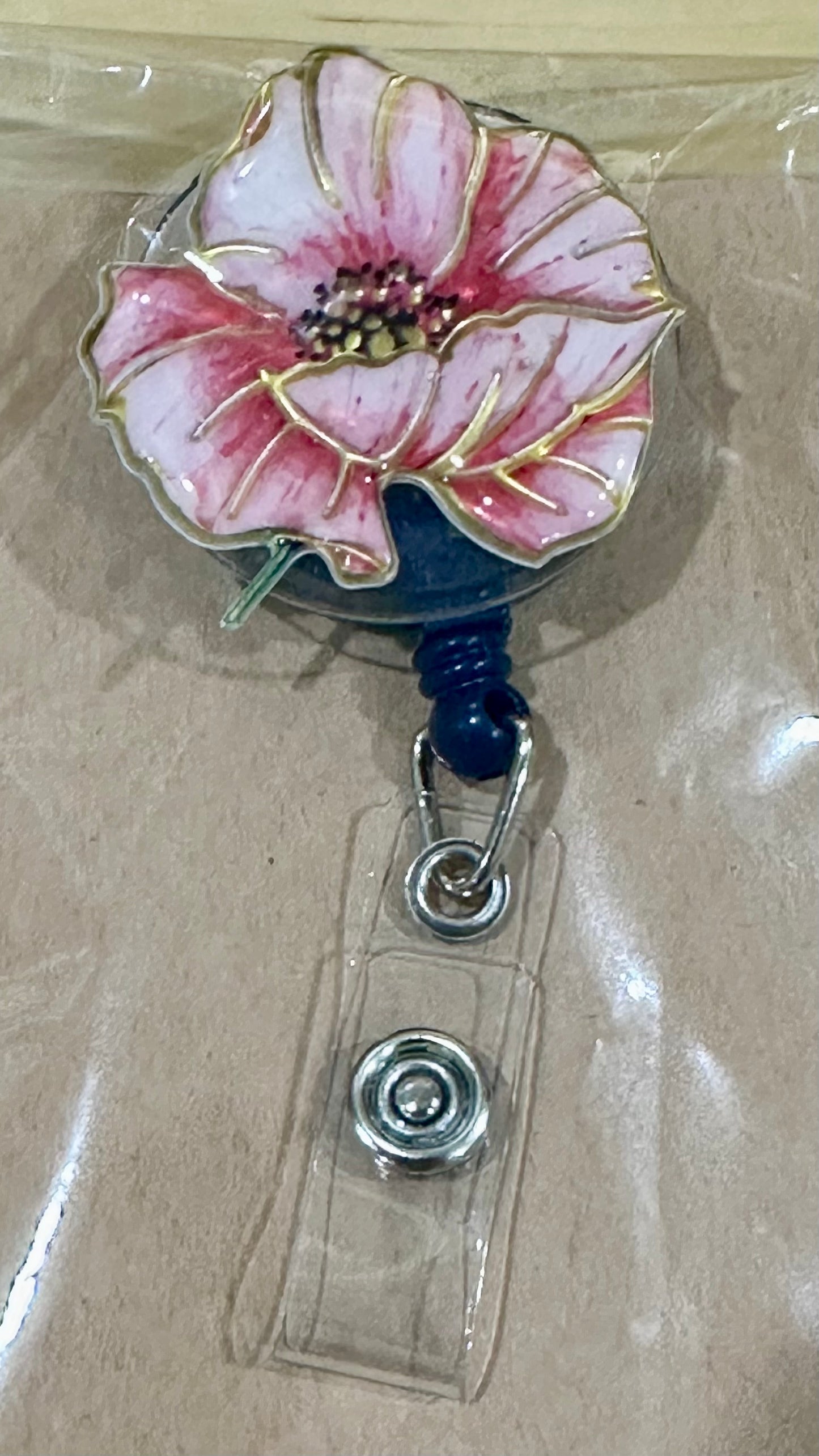 Pink flower badge reel with belt clip