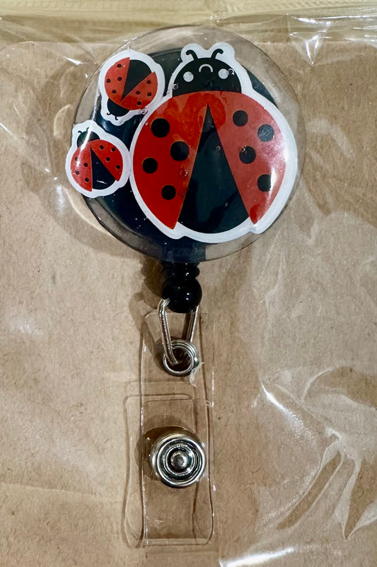 Lady bug badge reel with belt clip