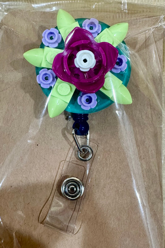Floral brick badge reel with belt clip