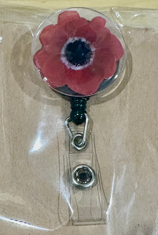 Red flower badge reel with belt clip